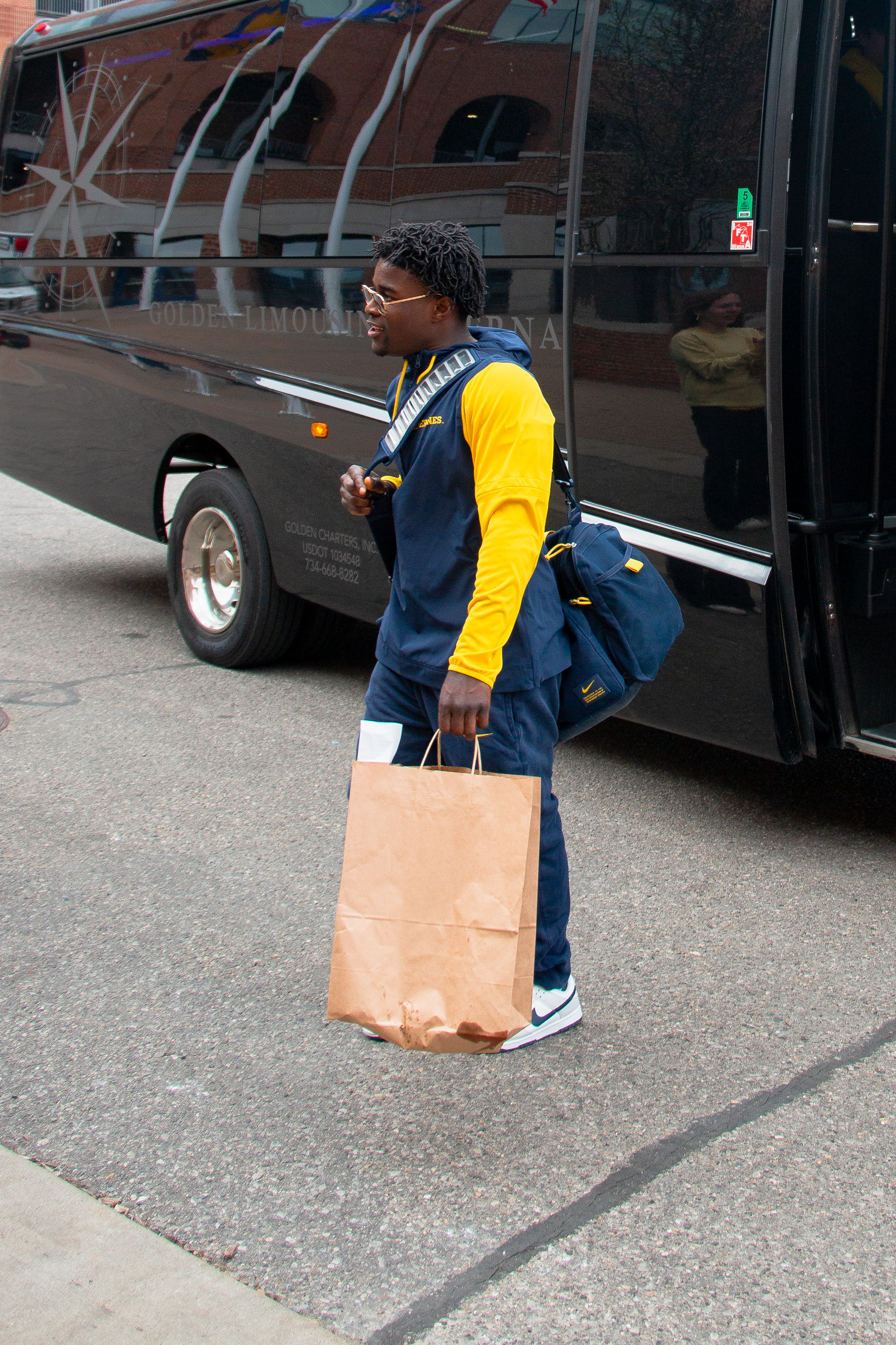 Michigan gymnast traveling with team equipment and gear